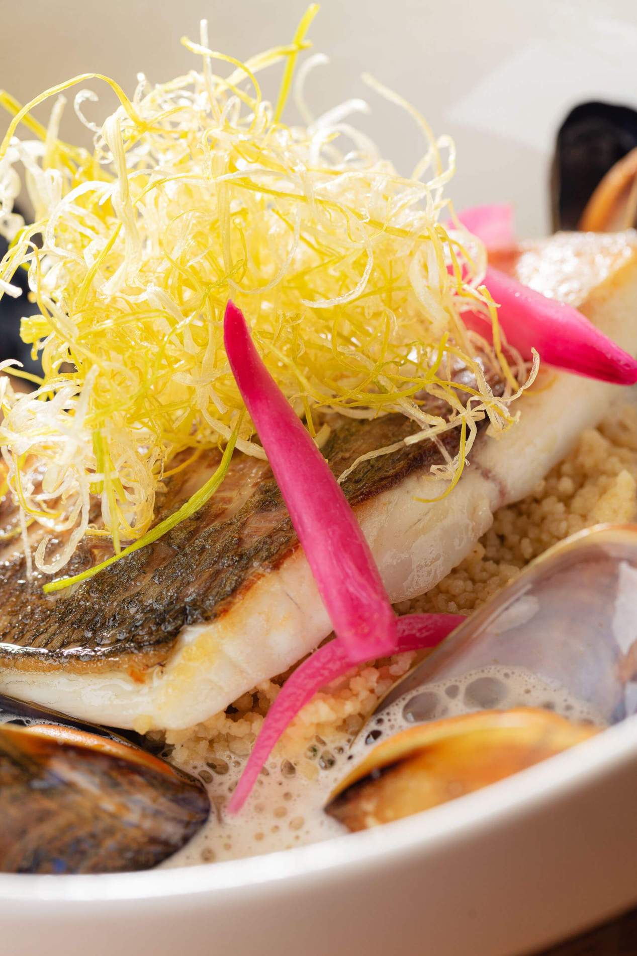 Poisson grillé, coquillages et semoule fine, gros plan